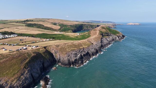 Aerial view of a coastal campsite on rugged cliffs in Wales, UK