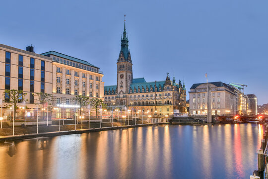 Rathaus in Hamburg, Germany, at dusk with reflections on Alster Canal
