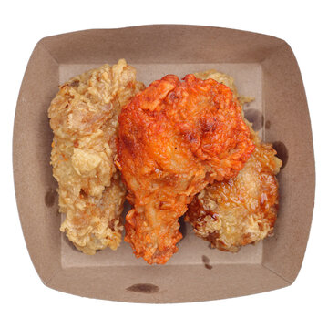 tasty fried chicken wings on paper box isolated on white.