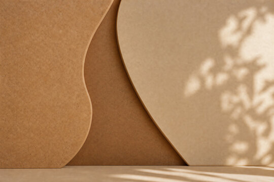 Minimalist cork background with organic curved shapes, abstract earth tone backdrop for product display, natural leaf shadow on beige textured surface