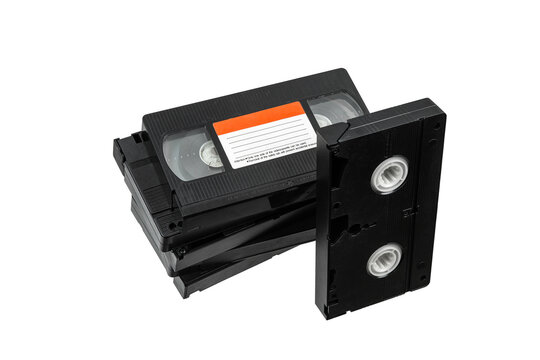 Stack of retro black VHS video cassettes isolated on a white back