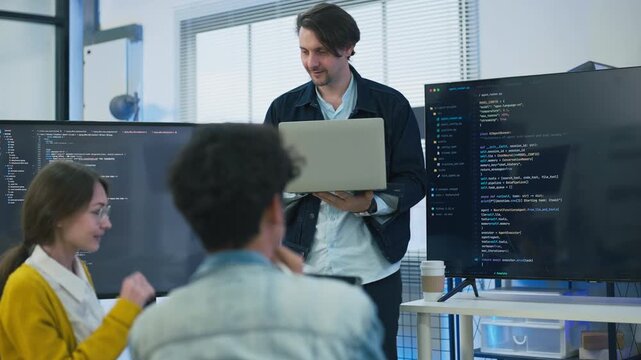 Businessman presenting voice AI software on screen to diverse team for sales report marketing campaign tech startup creative collaboration strategy hybrid workspace office background	