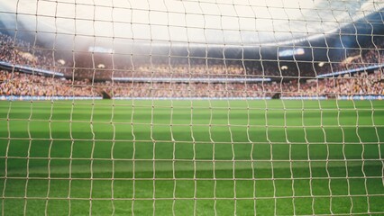 Selective focus goal net and post detail on football pitch under stadium light, side post of rope with knots and blurred soccer field behind, highlighting sports equipment in foreground. © DC Studio