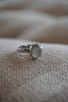 Silver ring with gemstone on linen fabric
