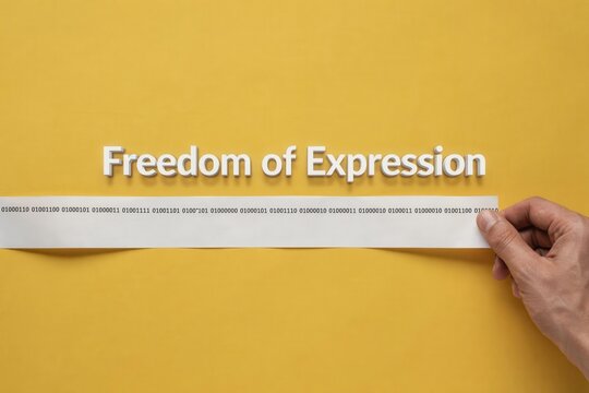 Freedom of Expression text on yellow background, hand removing white tape from censored words, concept of free speech and human rights