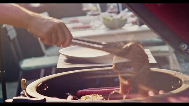 Cooking delicious meat and sausages on a grill during a summer backyard barbecue party.