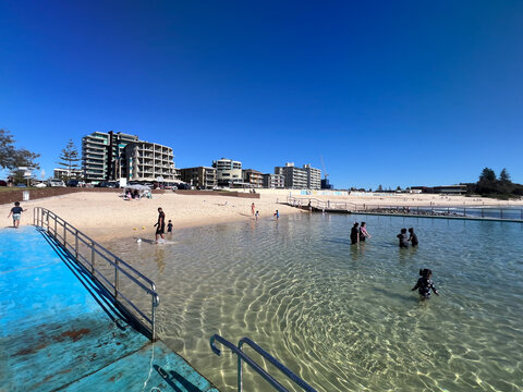 Sunny Forster Ocean Baths Tidal Pool with Swimmers at Main Beach, Australia
