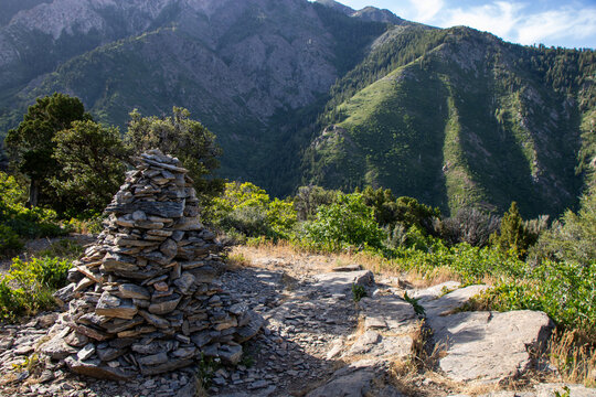 Stacked Rock Cairn Trail Marker on Hidden Valley Loop Trail via Taylor Canyon Above Ogden Utah in Summer with Wasatch Mountain Peaks Beyond
