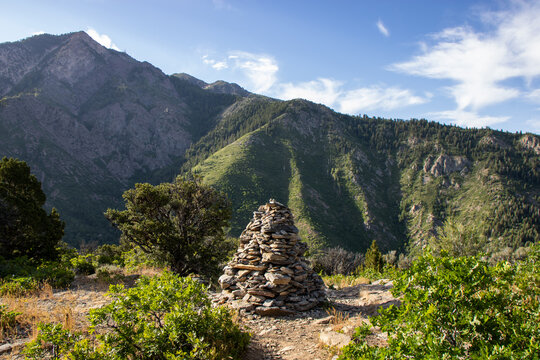 Stacked Rock Cairn Trail Marker on Hidden Valley Loop Trail via Taylor Canyon Above Ogden Utah in Summer with Wasatch Mountain Peaks Beyond