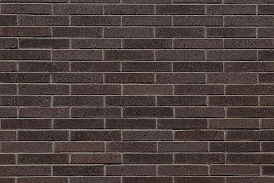 Dark brown brick wall texture with horizontal brick pattern. 