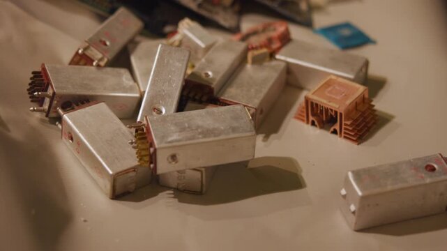 Top down view of chocolate bars stacking and rearranging on light surface with neutral background, creating organized food display in clean commercial setting with soft natural contrast