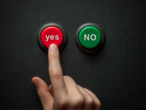 Human finger pressing a red yes button next to a green no button on a black textured panel symbolizing decision making and choice concept