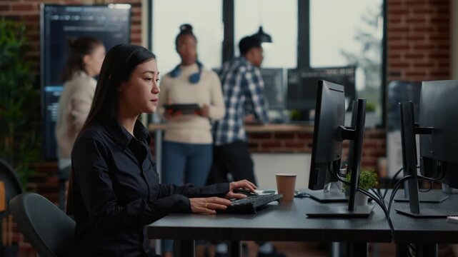 Asian software developer compares source code errors on a wall screen, connecting debugging, algorithm review and software diagnostics in an IT office, during a collaborative code session.