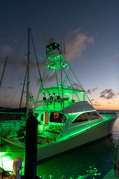 Luxury yacht at night. Night view. Yacht club. Marina in night. Summer vacation. Downtown city marina with luxury illuminated yacht. Docked vessels. Luxury yacht in night marina. Evening yachting