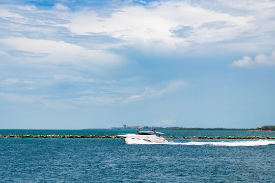 Luxury yacht heading out to sea from marina. Boating and yachting tourism. Luxurious lifestyle. Summertime vacation. Yacht at sea. Sea vacation on summer. Travel by sea. Luxury boat motor yacht