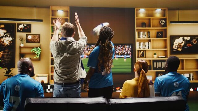 Upset football supporters curse players after a conceded goal while soccer fans show annoyed body language during a dramatic live game broadcast.