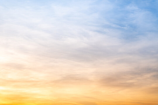 Sky sunset,Beautiful sunrise sky with vibrant gradient orange and gold colors and soft blue, Clear atmosphere with wispy clouds. Peaceful, perfect for background and copy space, High resolution images