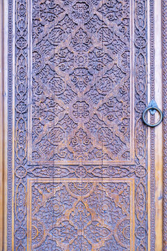 Intricate Hand-Carved Wooden Door with Islamic Floral Patterns