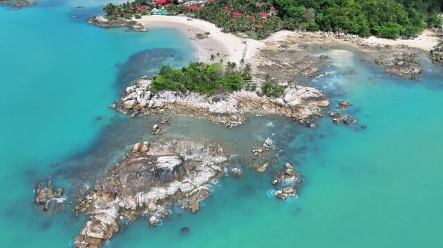 Majestic Aerial View of Parai Tenggiri Beach Featuring Turquoise Waters, Granite Rock Formations, White Sand Coast and Tropical Paradise in Indonesia