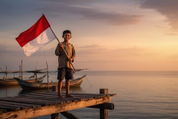 Naklejka premium Warm Smile of an Indonesian Child Carrying the Flag Against Traditional Fishing Boats