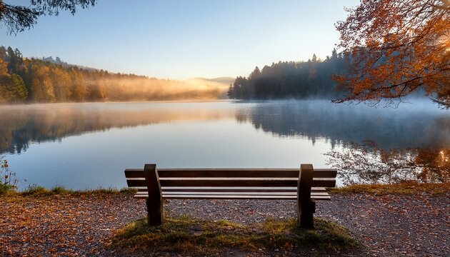 A Peaceful Empty Wooden Bench Overlooking A Serene Misty Lake During Autumn Symbolizing Reflection And World Mental Health Day