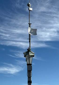 Security camera and antenna on top of a lamp on an ocean pier