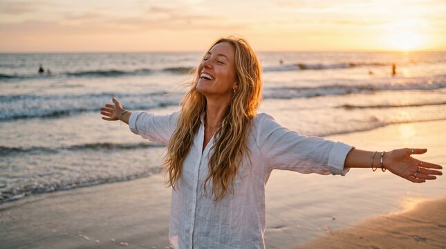 Carefree woman enjoying ocean breeze with arms outstretched at sunset carefree outdoors lifestyle vacation peaceful