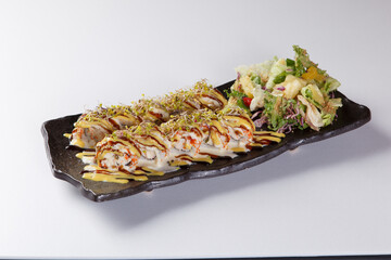Fresh salmon sushi roll with sauce on white plate © Donghyun Kim
