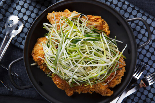 Korean fried chicken topped with shredded green onion padak