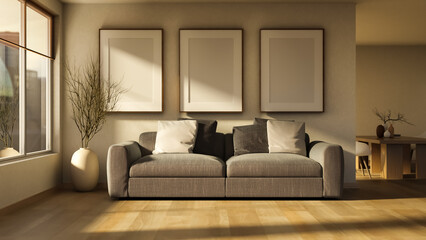 Fototapeta premium Elegant grey sofa with three blank mockup frames on wall.