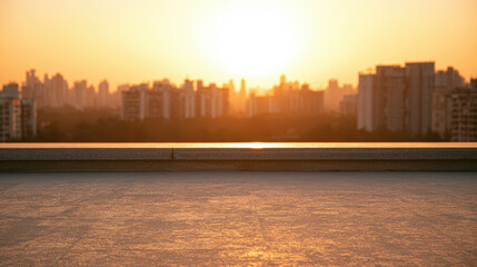 Obraz premium Sunset view of a city skyline with high-rise buildings silhouetted against an orange sky, seen from a rooftop with a textured surface.