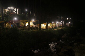 An evening in a tent amidst beautiful nature, featuring a "glamorous camping" theme. It is incredibly peaceful and romantic. © Sukma Rizqi