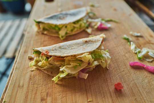 Stuffed wraps on a cutting board from a high angle