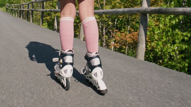 Skaters glide gracefully along a sunny trail as sunlight filters through trees, creating a beautiful backdrop for fun and freedom on wheels.