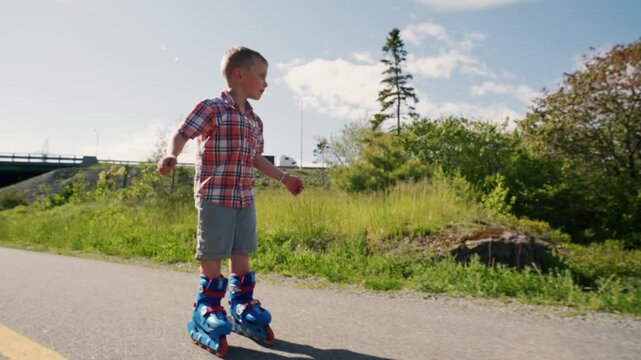 A young boy glides confidently on roller skates, showcasing his balance and enthusiasm. In the background, vibrant green trees and a peaceful path enhance the joyful atmosphere.
