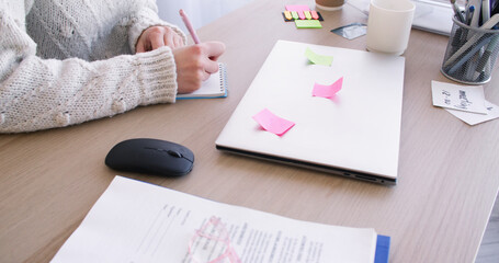 Work routine. Secretary desk. Unrecognizable female entrepreneur in office with paperwork laptop...