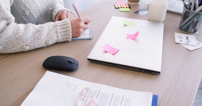 Work routine. Secretary desk. Unrecognizable female entrepreneur in office with paperwork laptop planning professional lifestyle.