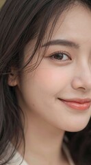 Fototapeta premium Close-up portrait of a smiling woman with natural makeup and smooth skin.
