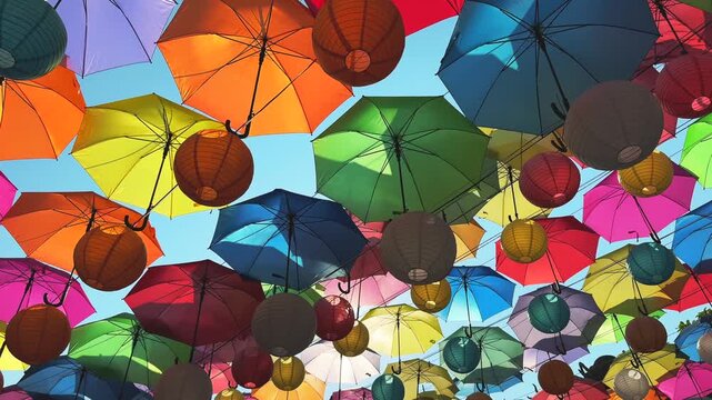 Walking under Colorful Umbrella roof Installation with Lanterns at Buddhist Temple
