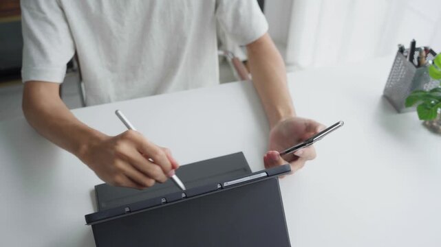 Asian businessman using tablet and holding smartphone