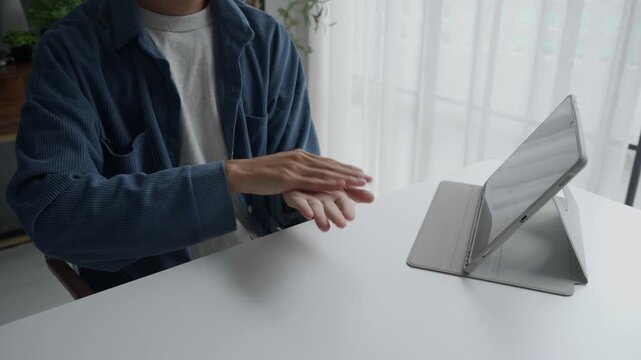Asian man learning to using sign language
