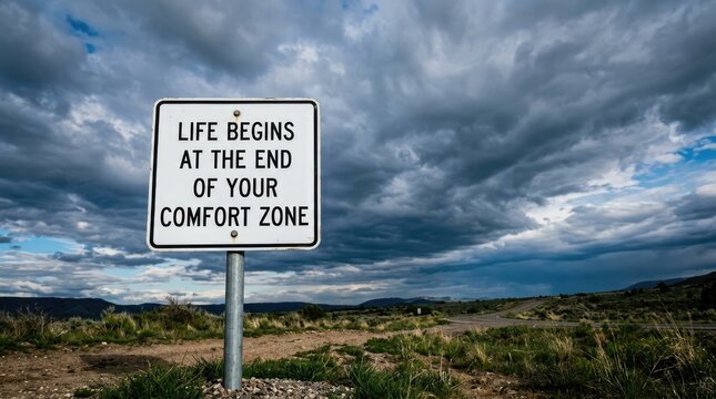 Metal road sign displaying an inspirational quote about pushing boundaries under a dark cloudy sky