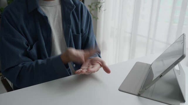 Asian man learning to using sign language