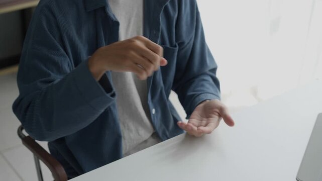 Asian man learning to using sign language