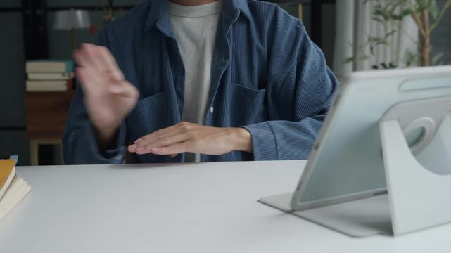 Asian man learning to using sign language