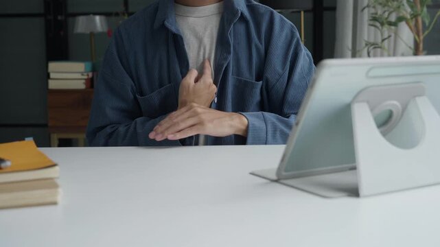 Asian man learning to using sign language