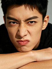 Naklejka premium Portrait of a Man Expressing Anger and Frustration, Human Emotions and Facial Expressions