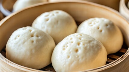 Fototapeta premium Close-up of four steamed buns in a bamboo steamer basket