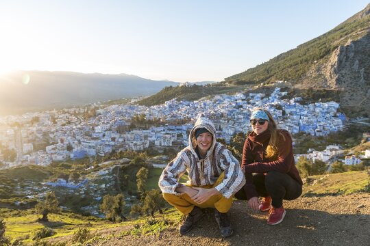 Young couple in Moroccan djellaba at lookout point, view on the medina of Chefchaouen, Chaouen, Tangier-T&eacute;touan, Morocco