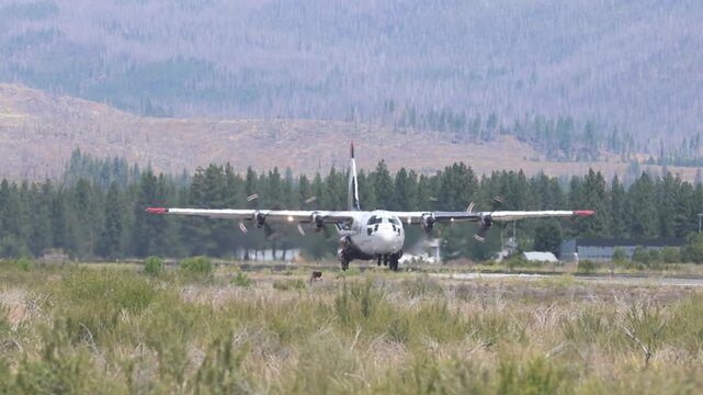A C-130 Hercules air tanker lifts off in slow motion from Rogers Field in Chester, California, heading to fight the Biscar Fire in Lassen County.